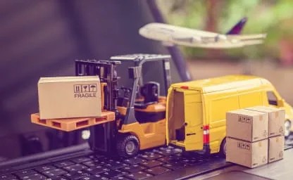 Mini Logistics - Model Forklift and Transport Vehicles Miniature forklift with a box labeled fragile near a delivery van and airplane